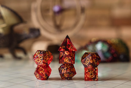 Set of red with metallic gold flake polyhedral dice on a gridded map