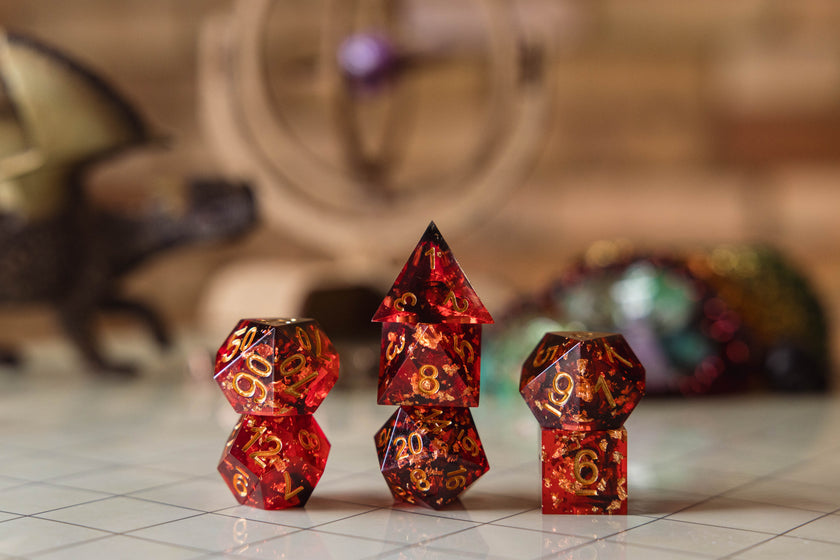 Set of red with metallic gold flake polyhedral dice on a gridded map